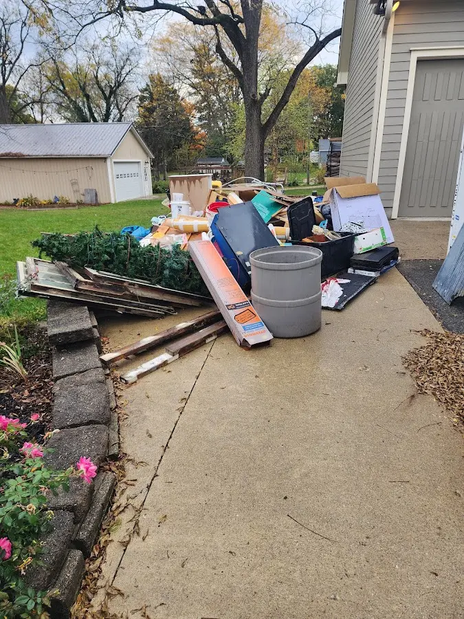 Dumpster being loaded with debris for 30 Yard Dumpster Rental in Bloomfield